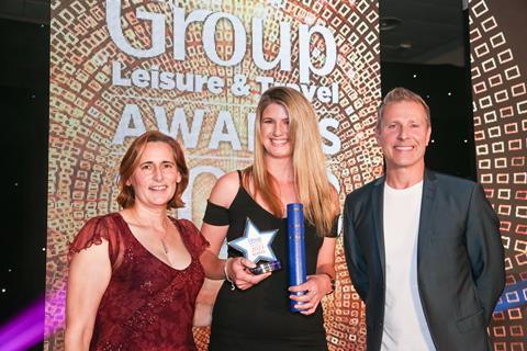 Florence Wallace (left) from the Great West Way® presents the GLT award on behalf of Ascot Racecourse to Charlie Crowther from Monkey World, alongside host Paul Zerdin.